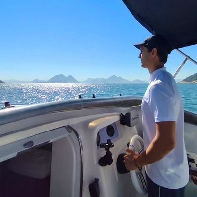 Smiling passenger on board with a view of Sugarloaf Mountain and Christ the Redeemer