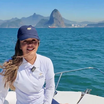 Crew member at the helm during a tour of Guanabara Bay